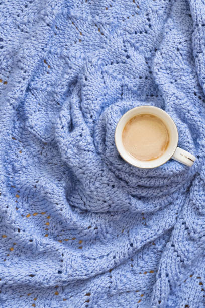 istock Cup of coffee on warm blue blanket. Winter mood concept. Image with copy space, top view 1184040820