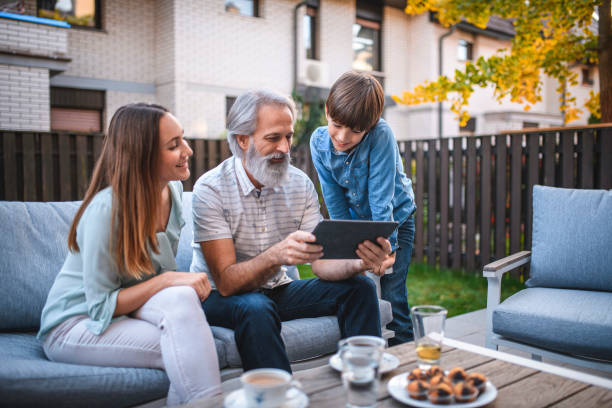 istock Senior Man, his Daughter and Grandson Using Digital Tablet 1184041673
