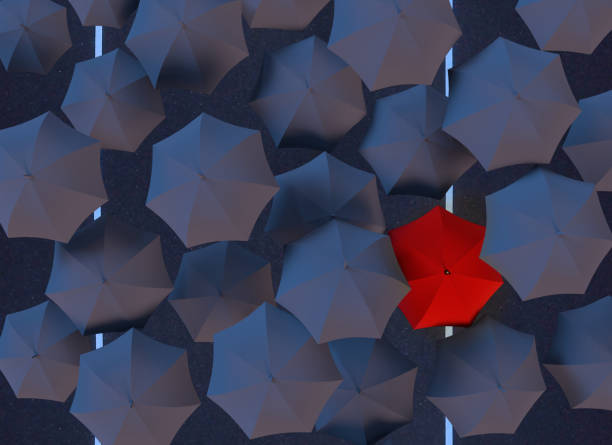 istock All black umbrellas but one red one 1184041959