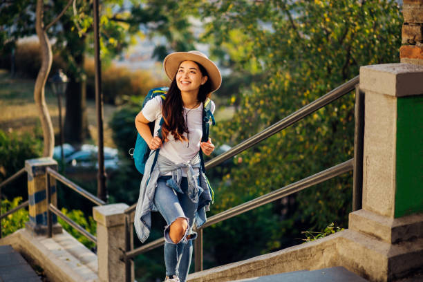 istock Asian girl with a backpack enjoying while sightseeing the city 1184042945