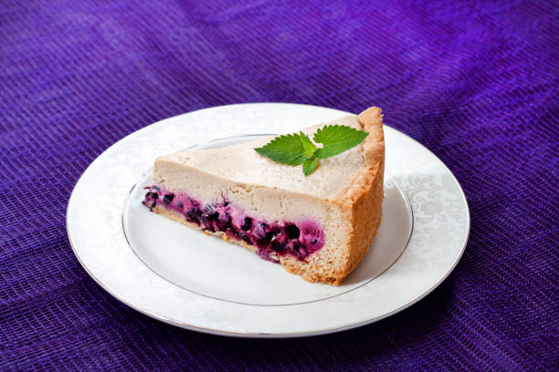 istock Slice of coffee cake with blueberries on a white plate 1184043614