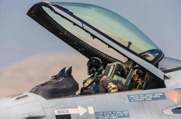 Pilot in the cocpit of an F-16 fighter jet plane. Pilot in the cocpit of an F-16 fighter jet plane. air force stock pictures, royalty-free photos & images