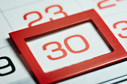 the thirtieth day of the month highlighted on the calendar with a red frame close-up macro, the mark on the calendar, the thirtieth date