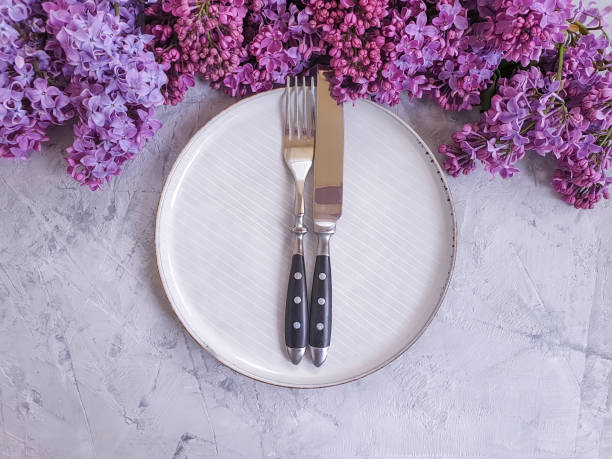 istock plate flower lilac on a concrete background 1184045519