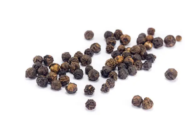 black pepper grains isolated on white background