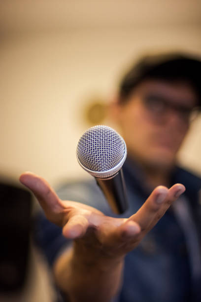 istock Closeup of a microphone floating on a hand 1184048539