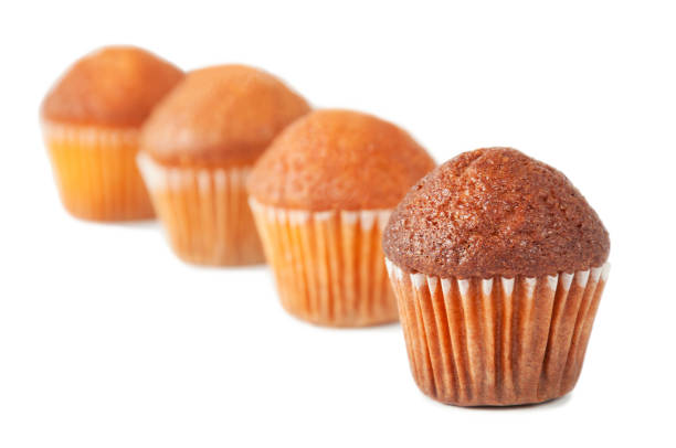 istock Chocolate and lemon muffins stand in a row isolated on a white background, selective focus. 1184048783