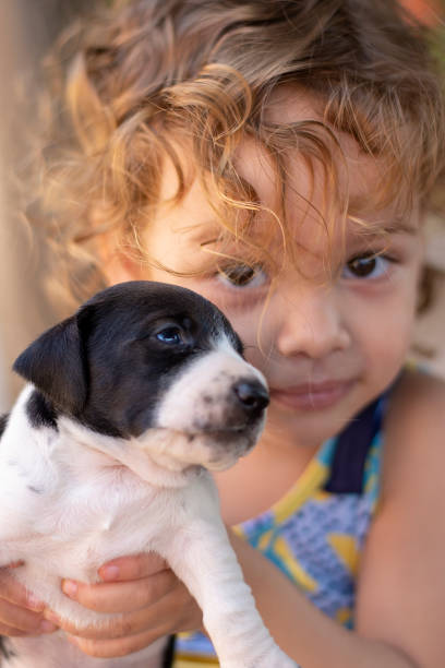 istock Beautiful child playing with puppy 1184052191