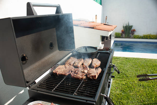 istock Cooking meat on the grill using gourmet specialty tools 1184057921