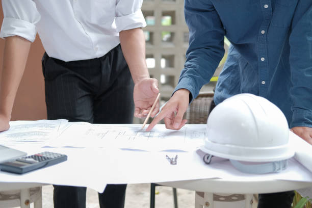 istock architect engineer working on house blueprint of real estate project. building construction concept 1184061602