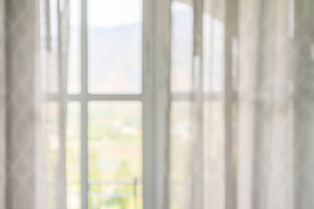 istock window curtain with green garden abstract blur background 1184062171