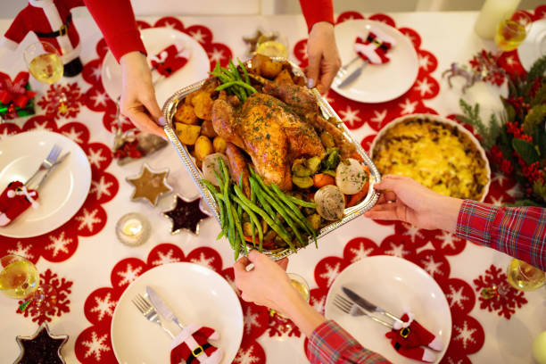 istock Family with kids having Christmas dinner at tree 1184064562