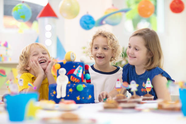 istock Kids space theme birthday party with cake. 1184064733