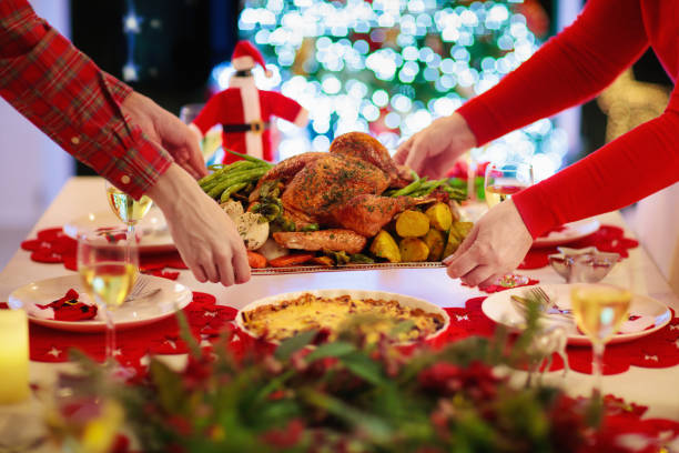 istock Family with kids having Christmas dinner at tree 1184064908