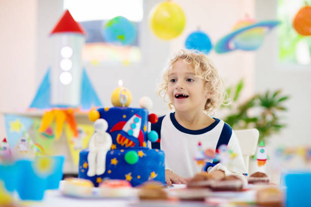 istock Kids space theme birthday party with cake. 1184065797