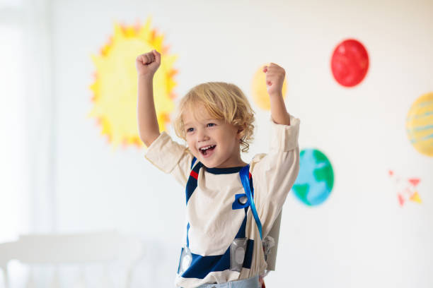 istock Kids play astronaut. Space and planet child game. 1184066173