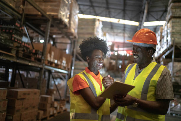 istock Father and daughter or coworker using tablet at warehouse 1184068831