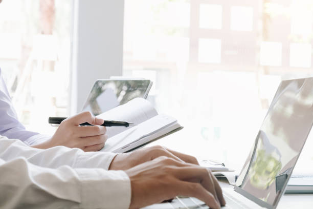 istock two accounting Concepts, Male use notebook, pen and computer laptop to working financial and budget, inspector accountant concept. 1184079006