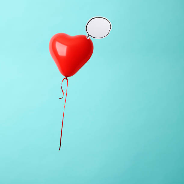 istock Red heart-shape balloon with blank speech bubble in mid-air. 1184080292