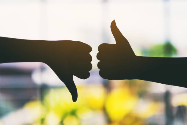 istock two hands making thumbs up and thumbs down sign 1184080537