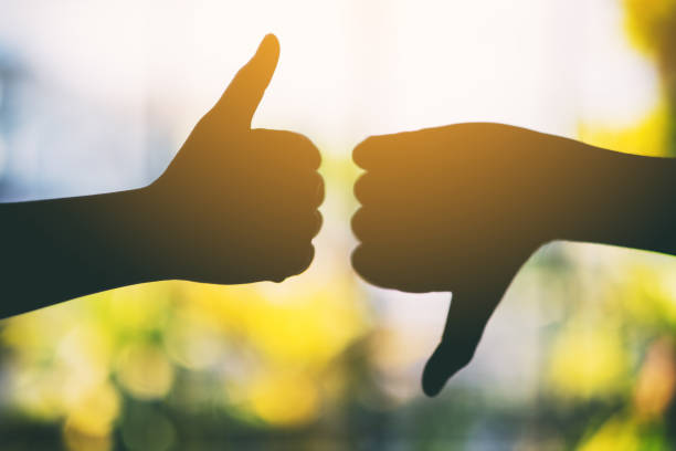 istock two hands making thumbs up and thumbs down sign 1184080548
