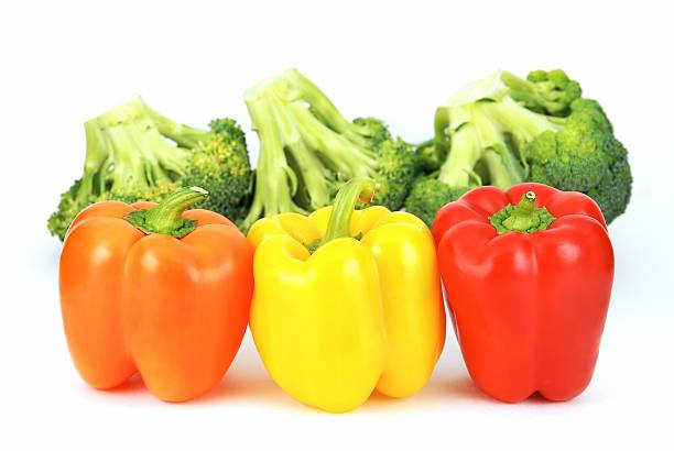 Collection of colorful pepper vegetable pieces, slices and leaves isolated on white background.