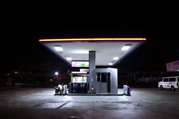 Empty gasoline station and gas pumps at night. stock photo