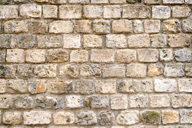 istock Rough brown natural stone wall 1184092308