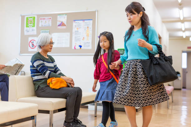istock Mother and Daughter Walking Through a Hospital 1184097639