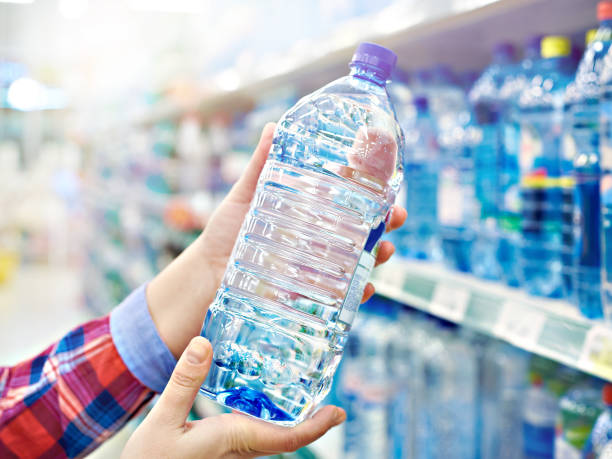 istock Buyer with bottle water in shop 1184100417