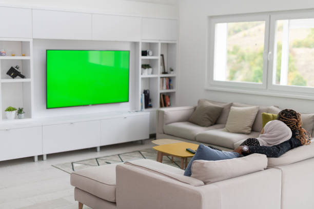 Defocus abstract blurred background of the interior. Beautiful interior of modern living room with sofa, armchair, coffee table and tv