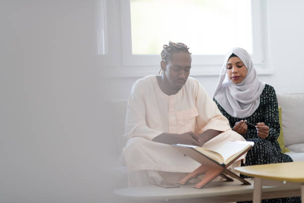istock African couple at home reading Quran 1184105456