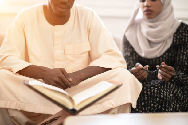 istock African couple at home reading Quran 1184109325