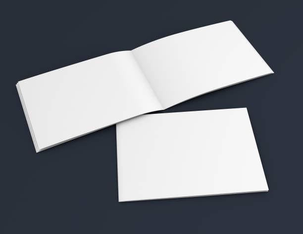 istock Two advertising landscape orientation catalogues on dark blue background. 1184110792