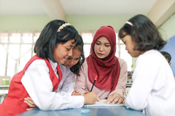 istock Student listening to teacher in classroom 1184113053