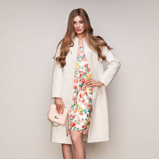 istock Young woman in white autumn coat 1184120030