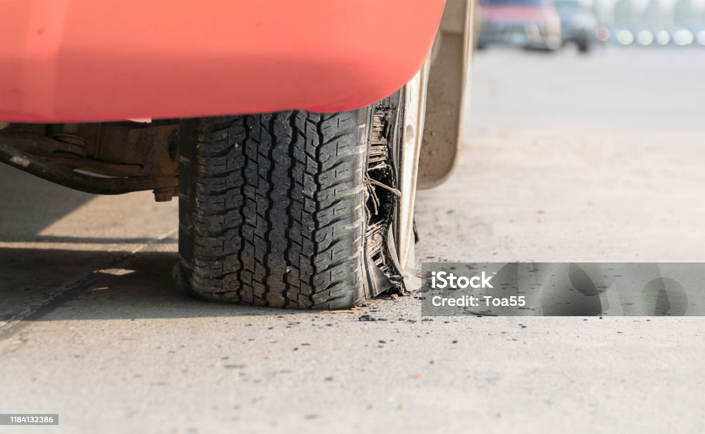 burst tire on the road Flat Tire Stock Photo