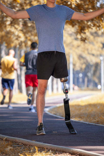istock Unknown young man without leg with prosthesis exercise in nature. 1184133648