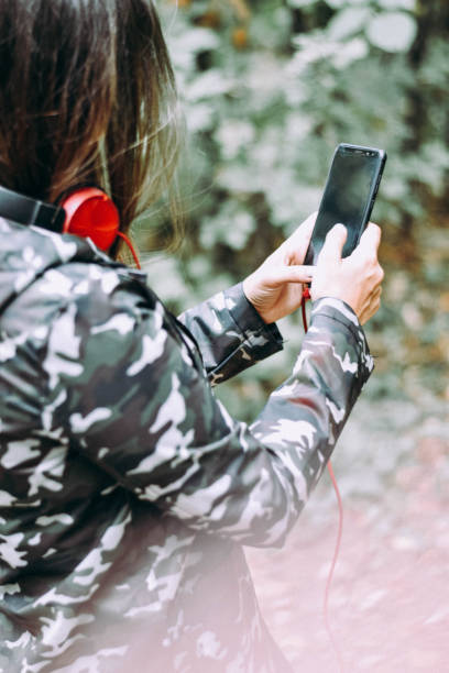 istock Young Female Listening Music Using Smartphone 1184133655