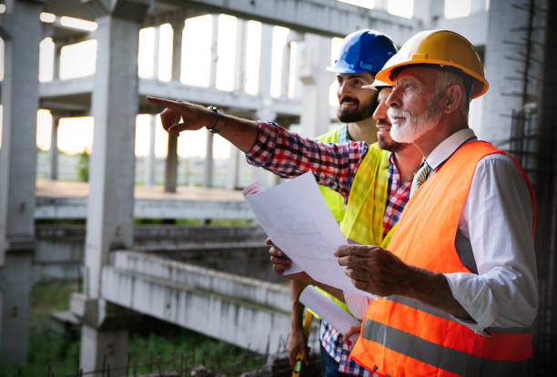 istock Architects, business manager and engineer meeting project at construction site 1184134281