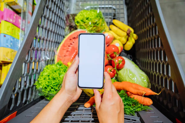istock phone with empty blank white screen shopping cart on background copy space 1184136336
