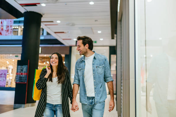 istock Young couple shopping in the mall 1184136478