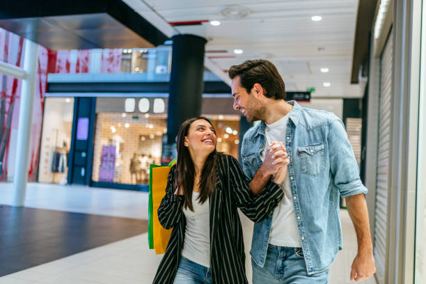 istock Young couple shopping in the mall 1184136671