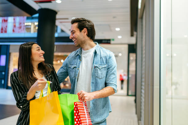 istock Young couple shopping in the mall 1184137564
