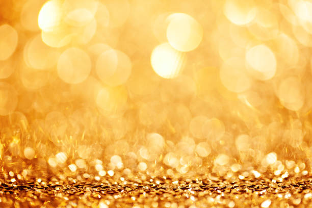 istock Golden holiday background bokeh. Abstract background. Selective focus. 1184137689