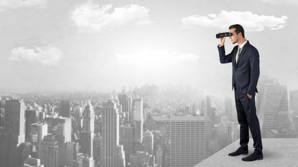 istock Man looking forward from the top of a skyscraper 1184138233