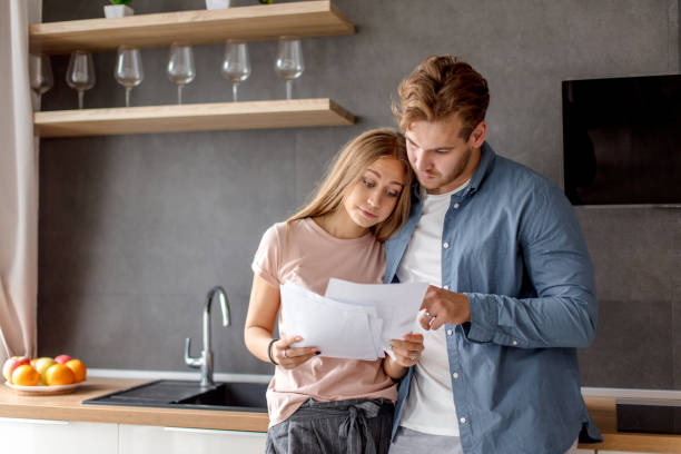 istock surprised unhappy couple has informed about debt 1184138413