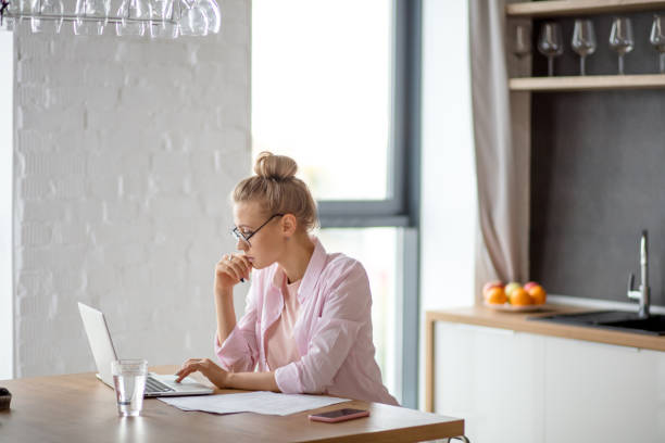 istock young awesome female freelancer working on notebook indoors 1184139086