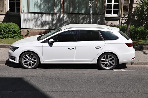 White Seat Leon station wagon car parked in Germany. There were 45.8 million cars registered in Germany (as of 2017).