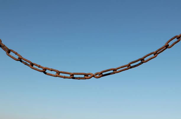 istock Old rusty chain on a background of blue sky 1184148406